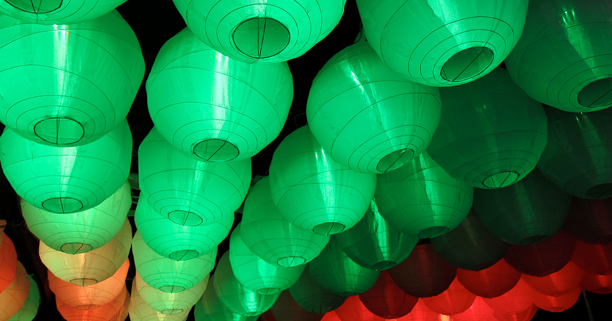 A workbench with electronics components, a soldering iron, and a 3D printer in the background